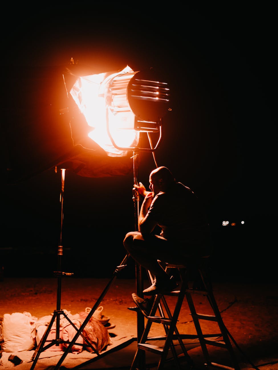 a man sitting by a studio light