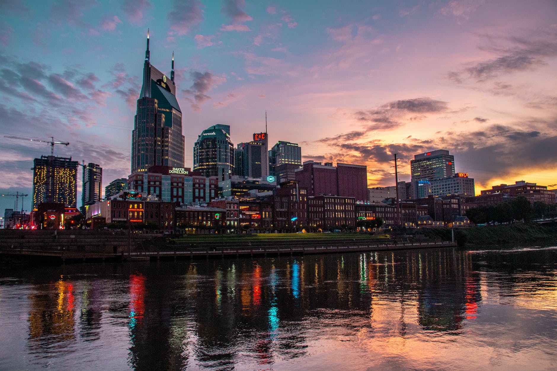 a city skyline is reflected in the water