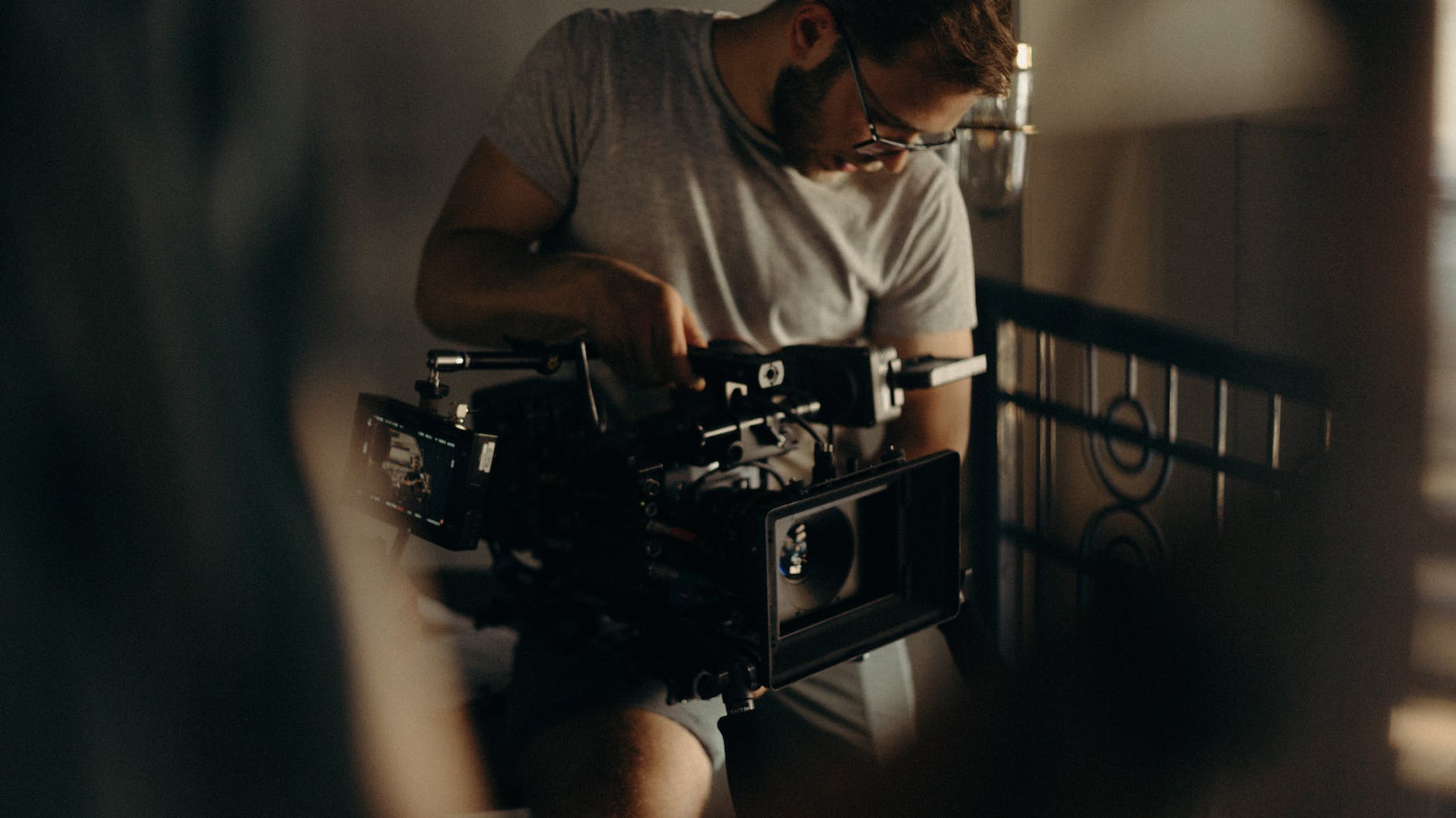 man in gray crew neck t shirt holding a camera