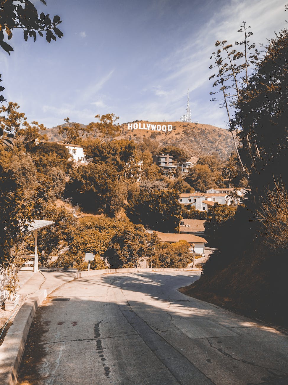 hollywood sign viewing houses under blue and white sky