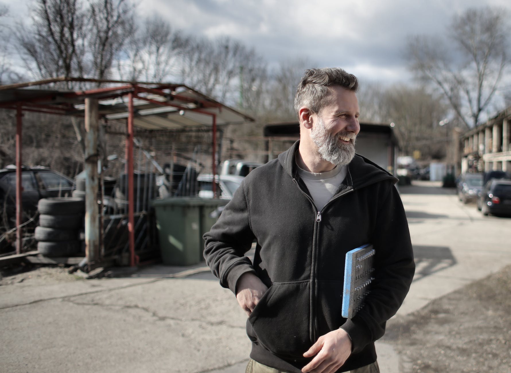 positive male worker with detail on street